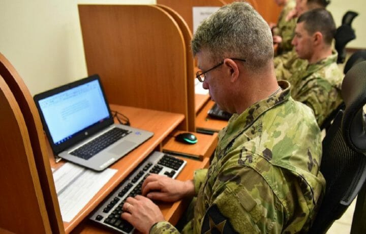 USMA man in uniform typing at computer