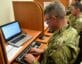 USMA man in uniform typing at computer