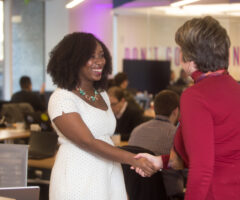 woman shaking another woman's hand at Booz Allen