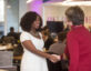 woman shaking another woman's hand at Booz Allen