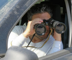 background investigator binoculars spying