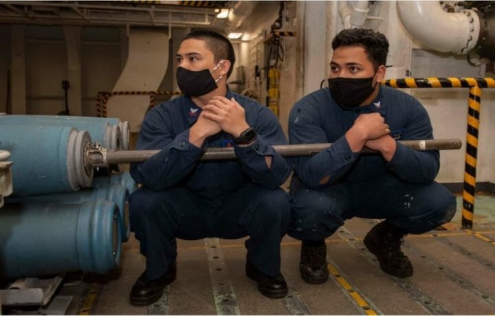 GHWB Sailors Lift Inert Bomb Body