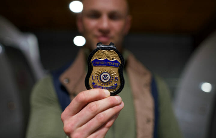man holding Federal Air Marshal Service Badge