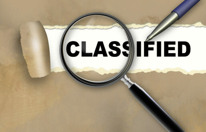 magnifying glass with classified pen