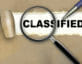 magnifying glass with classified pen