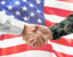 military man shaking hand of business man with american flag