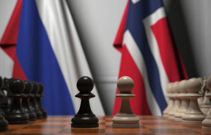 Flags of Russia and Norway behind pawns on the chessboard. Chess game or political rivalry related 3D rendering
