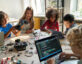 Diverse School Children Students Build Robotic Cars Using Computers and Coding.