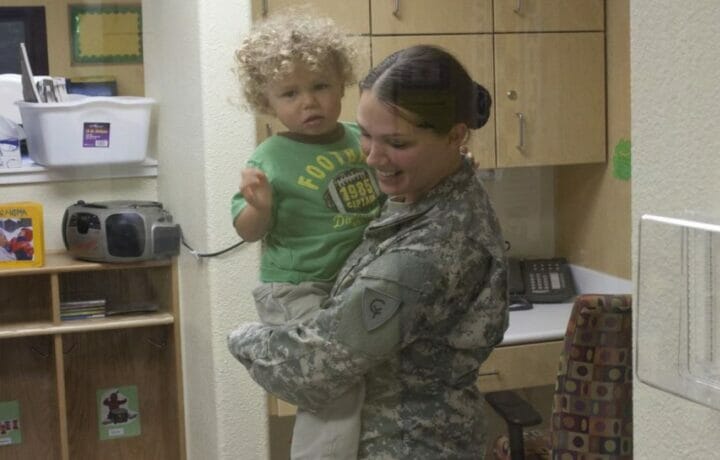 Spc. Jennifer Regis visits with her son, Corvin, after the opening ceremony of the new Child Development Center at Camp Atterbury Joint Maneuver Training Center, Ind., Oct. 3. The new CDC is the first facility of its type to open on a National Guard installation.