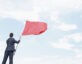 Businessman waving a red flag