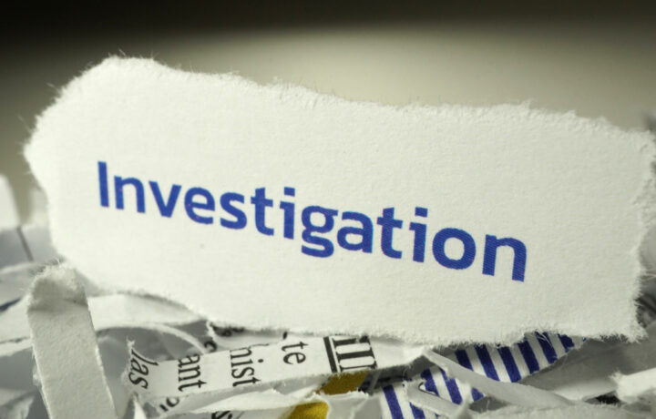 investigation written on shredded paper