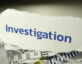 investigation written on shredded paper