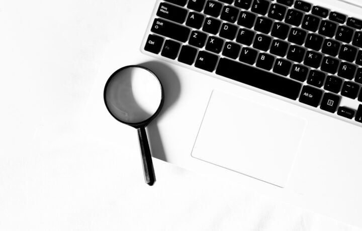 magnifying glass with keyboard laptop