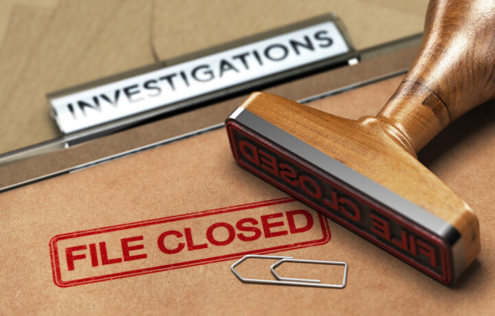 investigation file closed stamp with paperclip