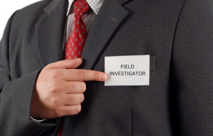 field investigator name tag man in suit