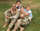 family in military uniform on grass