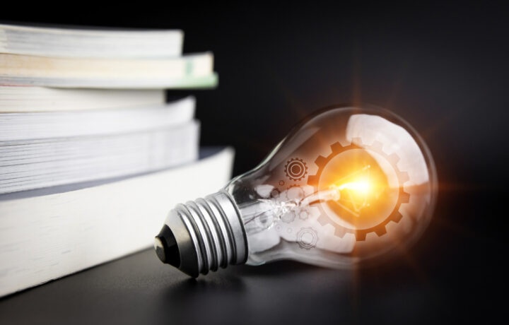 Light bulbs and books. Concept of reading books, knowledge, and searching for new ideas. Innovation and inspiration, Creativity with twinkling lights, the inspiration of ideas.