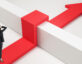 Graphic of a woman standing in front of a barrier with a big red arrow going over the hurdle.
