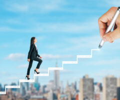 Image of a woman climbing steps that are being drawn, invoking a feeling she is paving her own path.