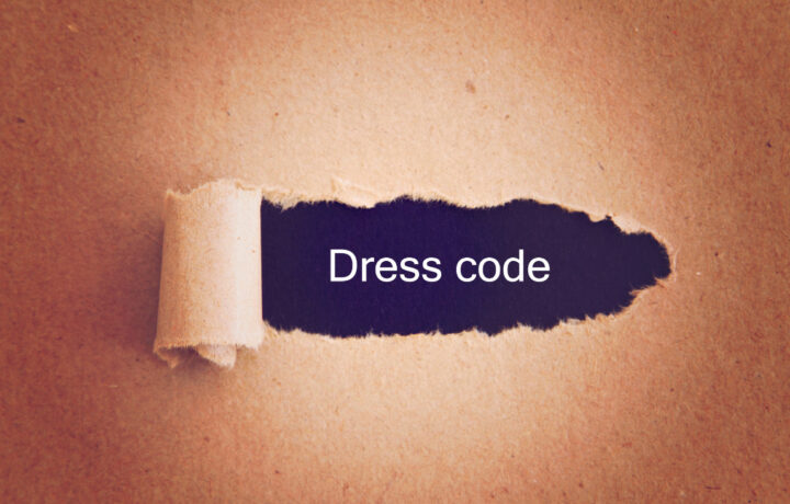 paper pulled back showing dress code