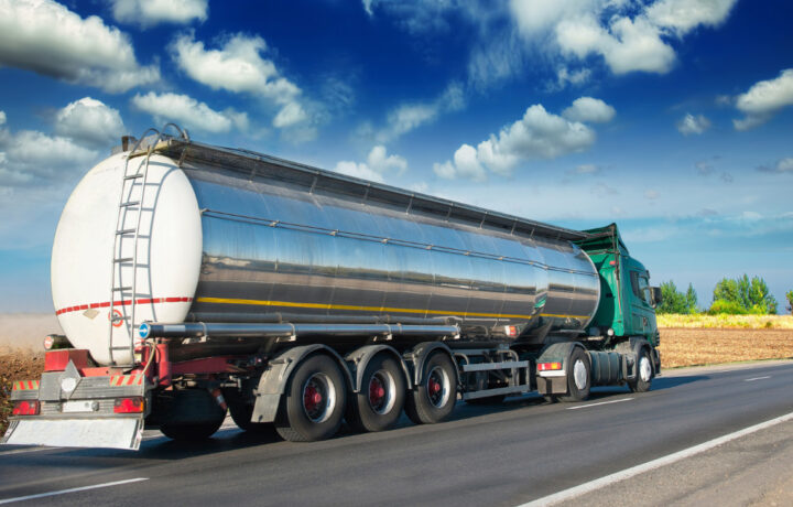 Photo of a fuel tanker with against a blue sky day in the midwest.