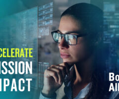 Photo of woman looking at a screen, with the screen reflected in the image. The words "Accelerate Mission Impact" are in the bottom left, and in the bottom right it says "Booz Allen."