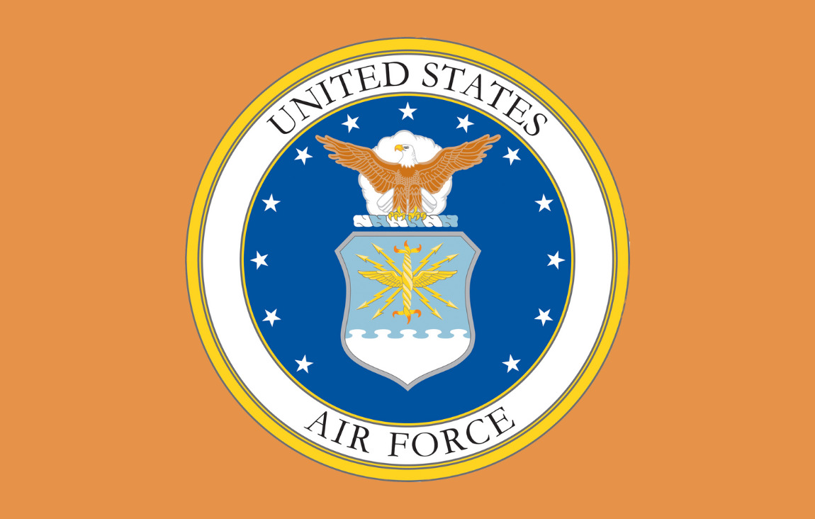Air Force Seal against a pale orange background.