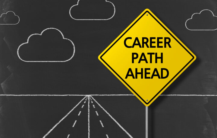 Career Path Ahead sign against a chalkboard drawing of a road and clouds.
