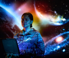 Photo of a female service member with space projections in the background.