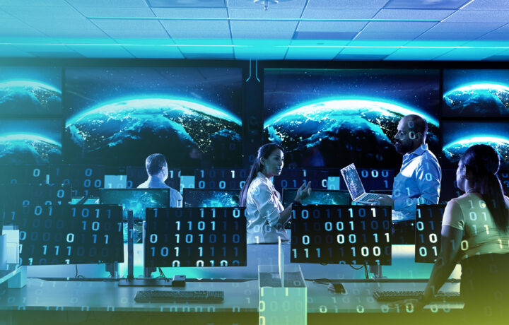 A high-tech operations center with multiple computer workstations and large screens displaying a digital rendering of Earth. A diverse team of cybersecurity or intelligence professionals, dressed in business casual attire, is engaged in discussion and analysis. The image has a futuristic overlay of binary code (1s and 0s), symbolizing data processing and cyber intelligence.