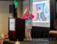 Lindy Kyzer introduces DCSA Director David Cattler during his virtual presentation at ClearanceJobs Connect 2025 West in San Diego.