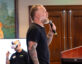 Tommy Weinert speaks on stage at ClearanceJobs Connect West, holding a microphone and addressing the audience, with a colorful parrot painting and another attendee in the background wearing a VR headset.